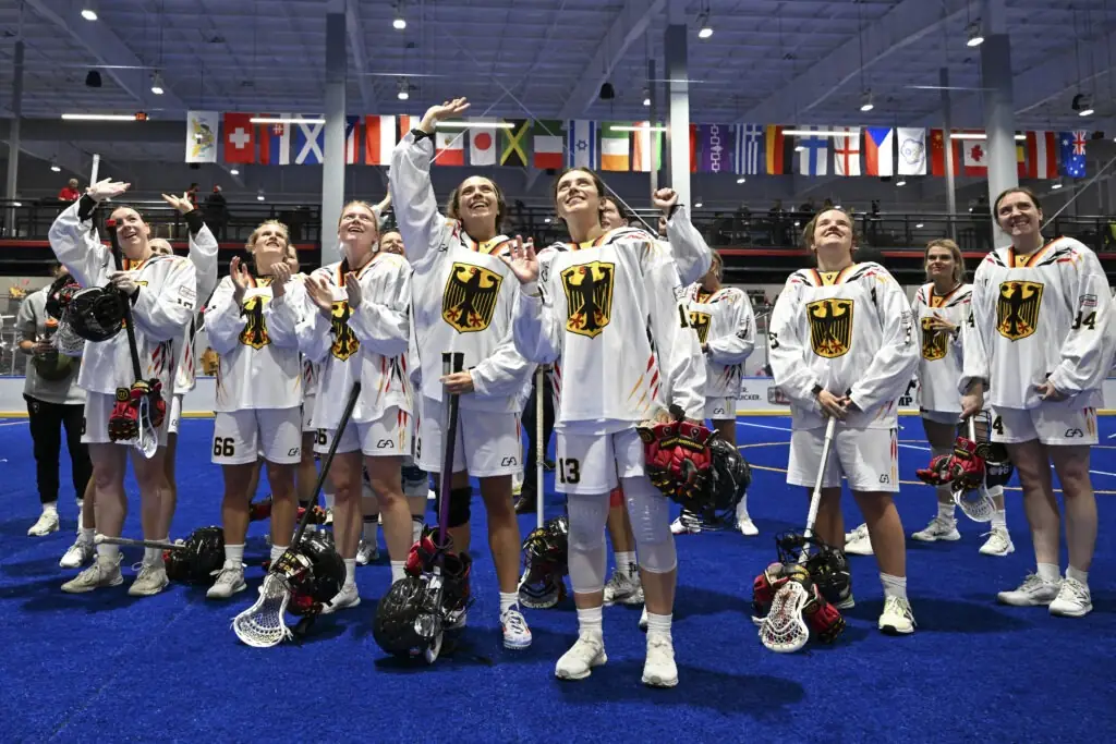 Germany's women's lacrosse team celebrating on the pitch